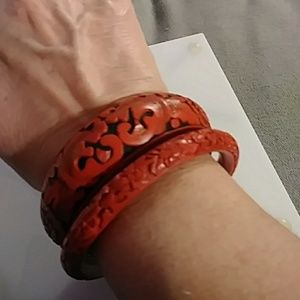 Two carved cinnabar bracelets